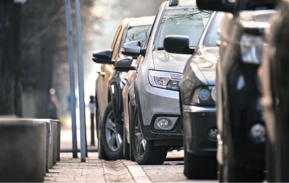 Stadtverkehr mit geparkten Autos auf der Straßenseite